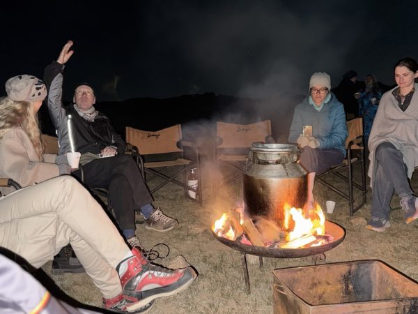 Mongol connections participants converse over an open fire.
