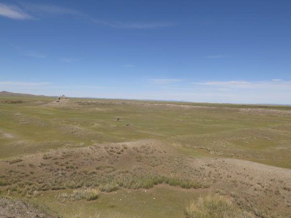 Mongolian landscape, blue sky over green land.