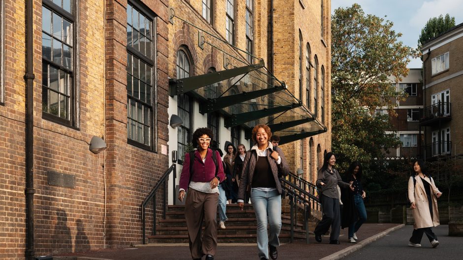 two female students smiling walking away from the Courtauld building