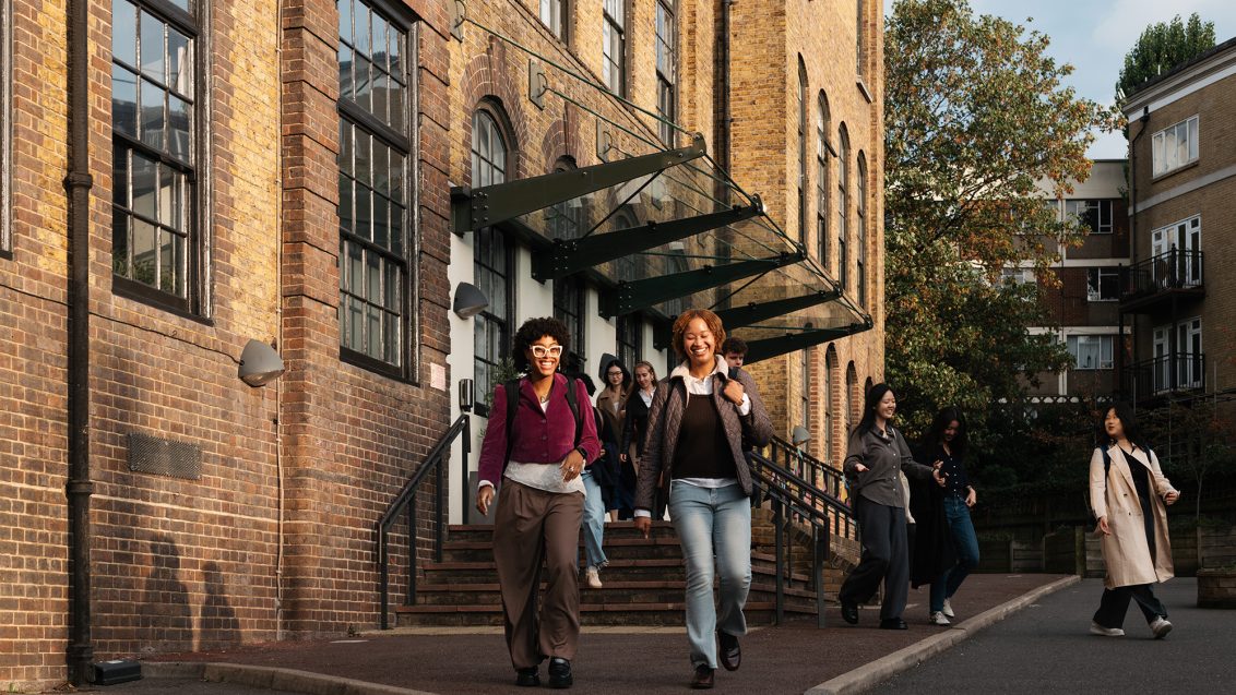 two female students smiling walking away from the Courtauld building