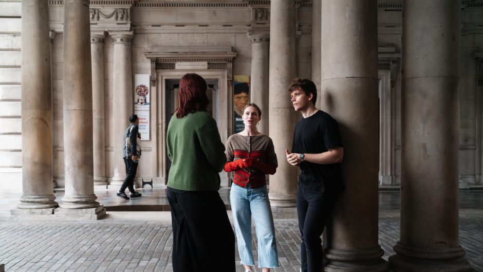 Three students talk in the arches outside Somerset House