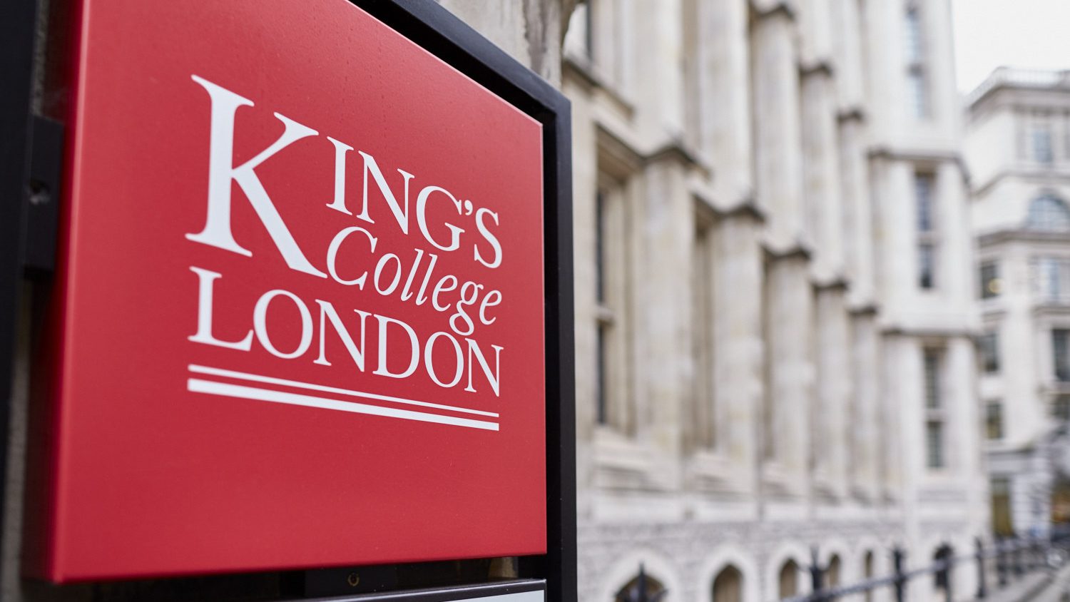King's College London campus on the Strand, the red KCL sign on the front.