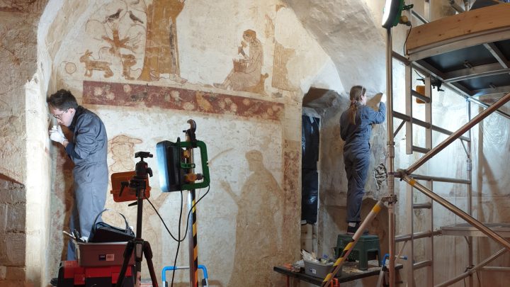 Students from conservation, work on location to restore a wall painting.