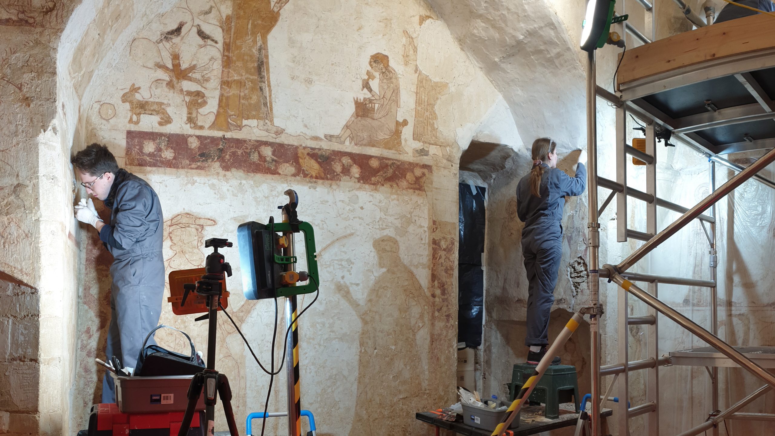 Students from conservation, work on location to restore a wall painting.