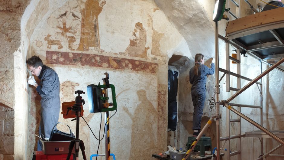 Students from conservation, work on location to restore a wall painting.