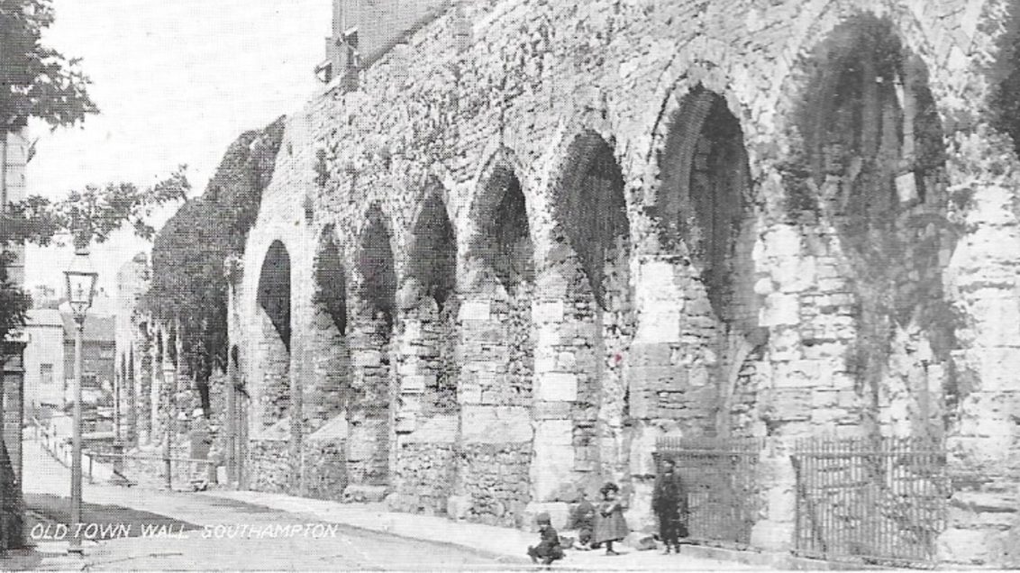 Black and white photograph of Southampton Old Town Wall, with three children by it