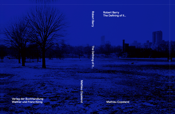 Book cover of Robert Barry, The Defining of It... depicting a snowed empty park in the foreground and a city in the background. The whole photograph has a blue tint over it.