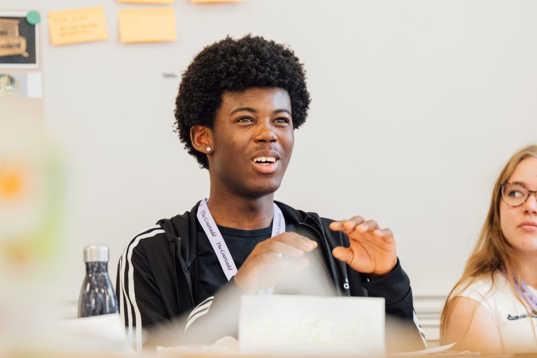 A student looking animated while in a seminar.