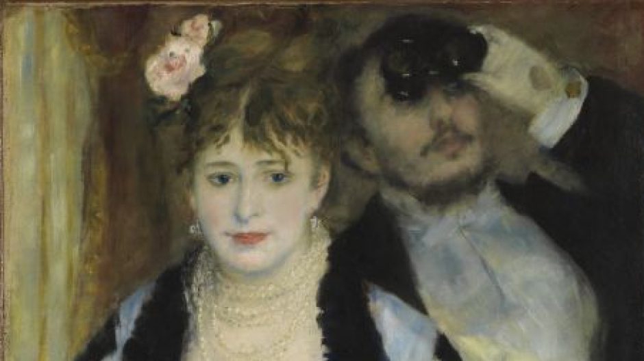 A woman looks out from an opera box