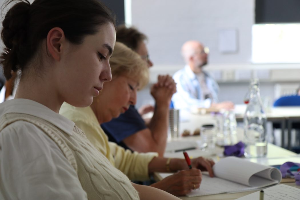 Students sit in classroom writing
