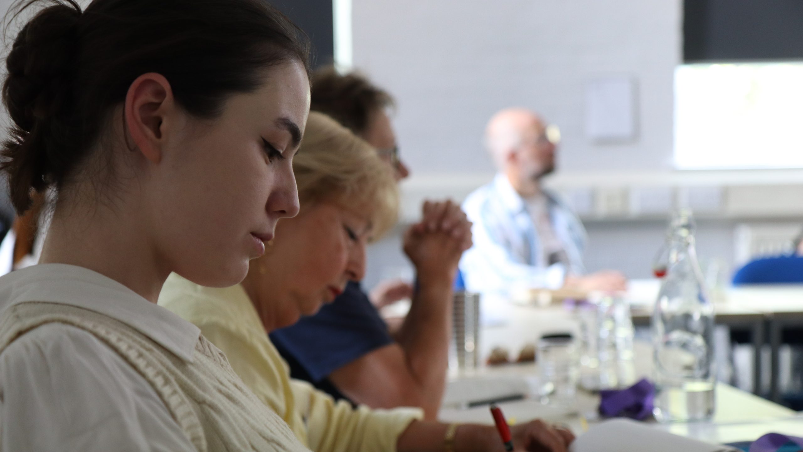 Students sit in classroom writing