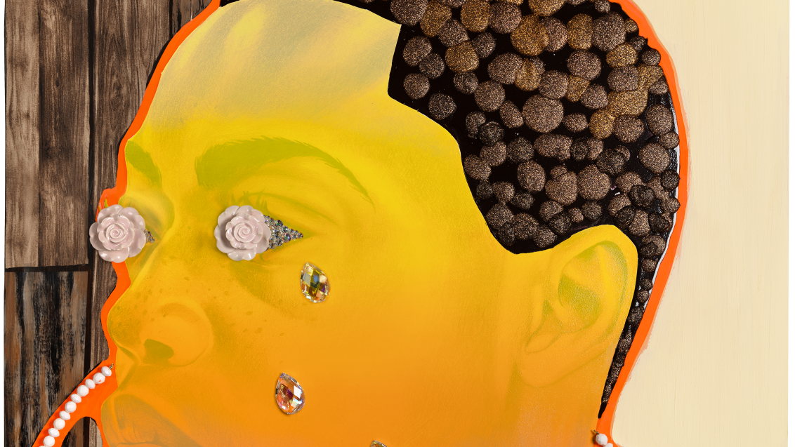 A mixed-media painting featuring the outlined figure of a person, painted in bright orange hues, with textured hair. A hair clipper is positioned above the head, with its cord, made out of plastic beads, looping around the composition. The background combines wood‑panel textures and light-coloured surfaces. There are costume jewellery elements collaged onto the eyes and cheeks of the figure, as if crying diamonds.