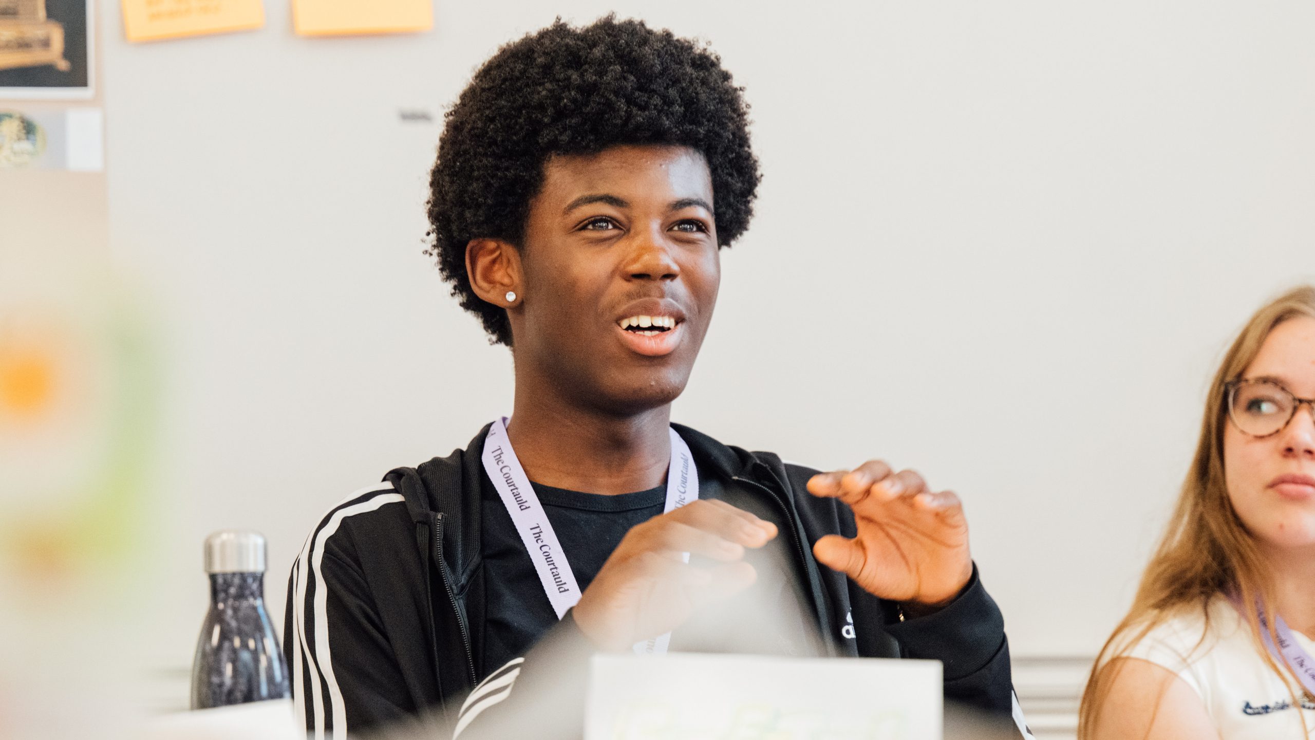 A student looking animated while in a seminar.