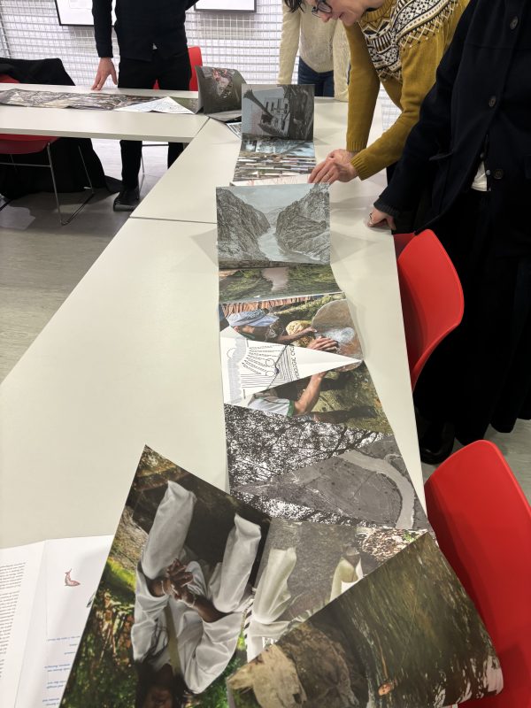 Concertina of images spread out on a table, hands lifting and looking at the images