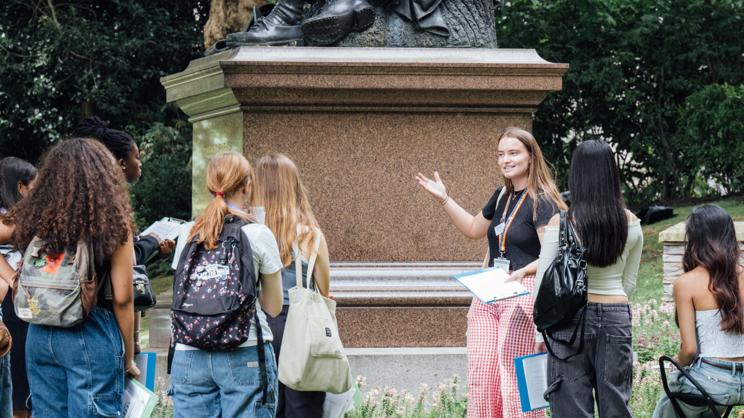 Summer University students stood by a public monument.