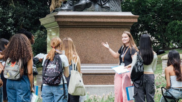 Summer University students stood by a public monument.