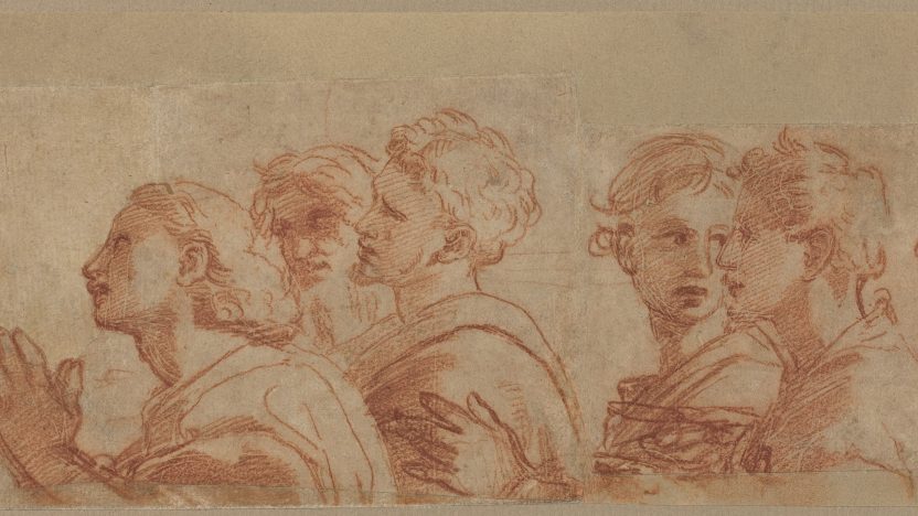 This drawing by Raphael is a sketch of several people facing the left, depicted from the chest up. The individuals are standing together in a group. Their hair is in a variety of styles, and they are dressed in draped garments. The person at the front of the group has their hands clasped together in front of their chest. The background is plain beige paper, and the lines of the drawing have been done in red.