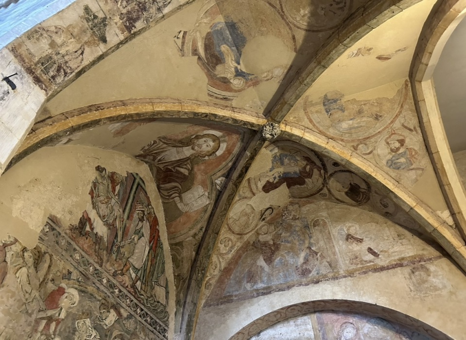 A gold, domed ceiling, painted with saints and angels