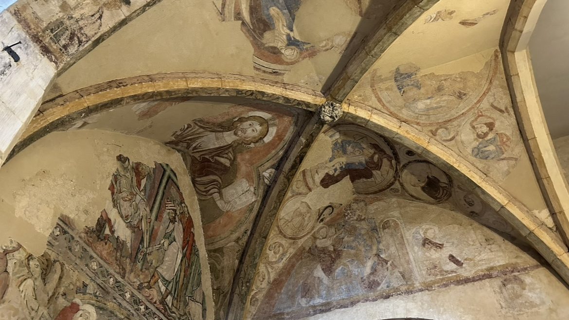A gold, domed ceiling, painted with saints and angels