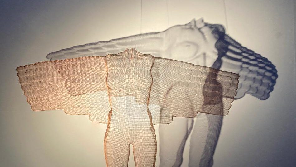 An image of an artwork featuring two figures surrounded by a shadow
