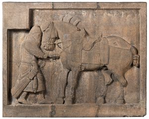 Bas-relief carving, limestone a man with a horse.