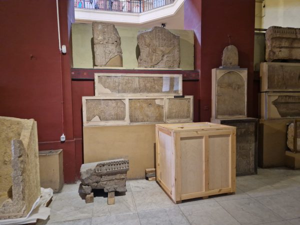 Display cases in a museum: Egyptian hieroglyphs and carvings on broken pieces of stone