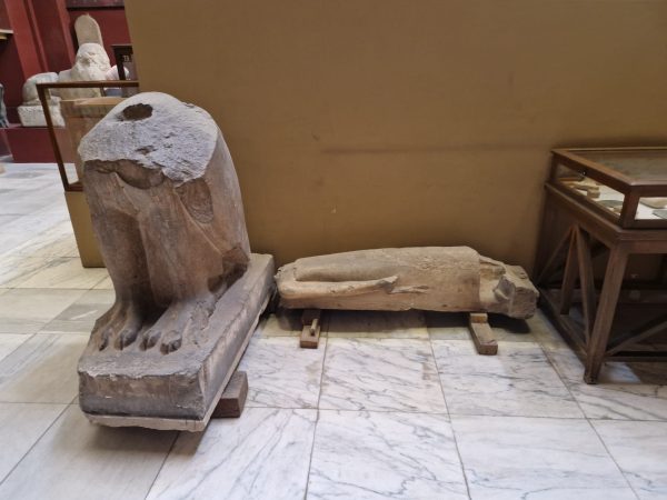 Two broken statues in a museum