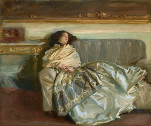 A woman lies on a sofa