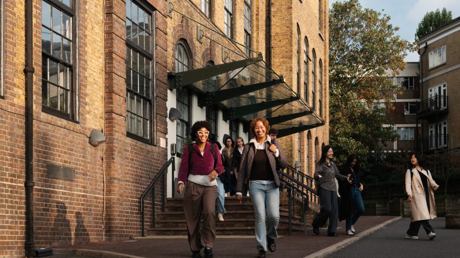 A number of smiling students exit the Courtauld Vernon Square campus.