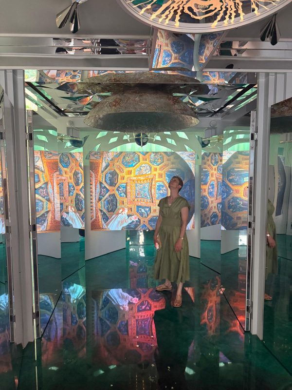 a figure stands in the exhibition space at The Cosmic House.