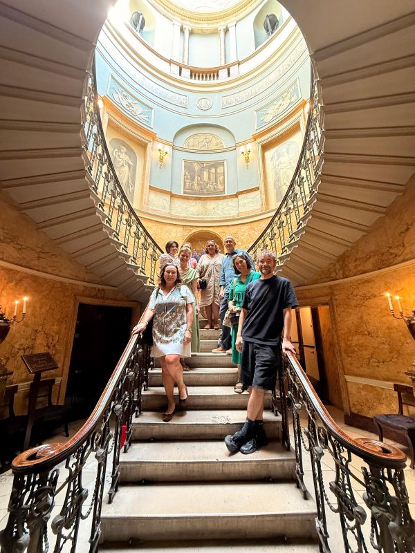 Members of the Interrogating Heritage research Cluster stand on the stairs of Home House