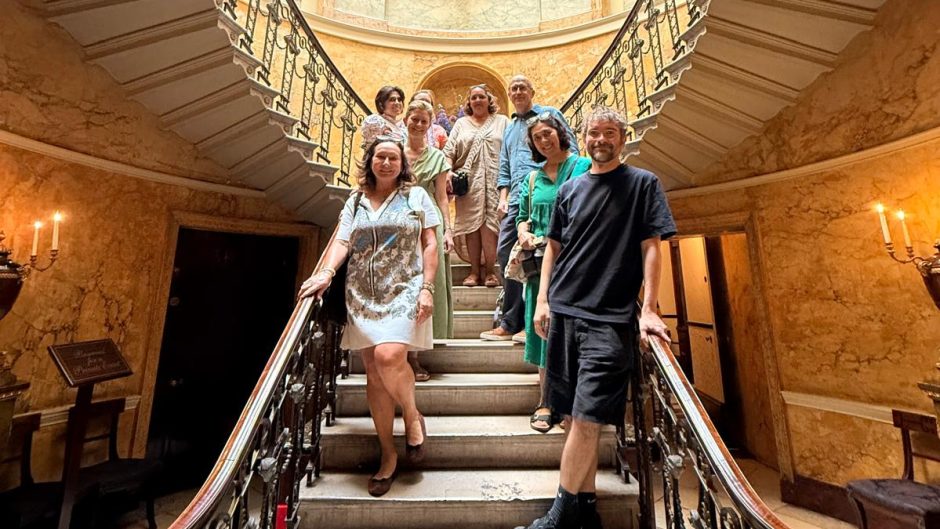 Members of the Interrogating Heritage research Cluster stand on the stairs of Home House