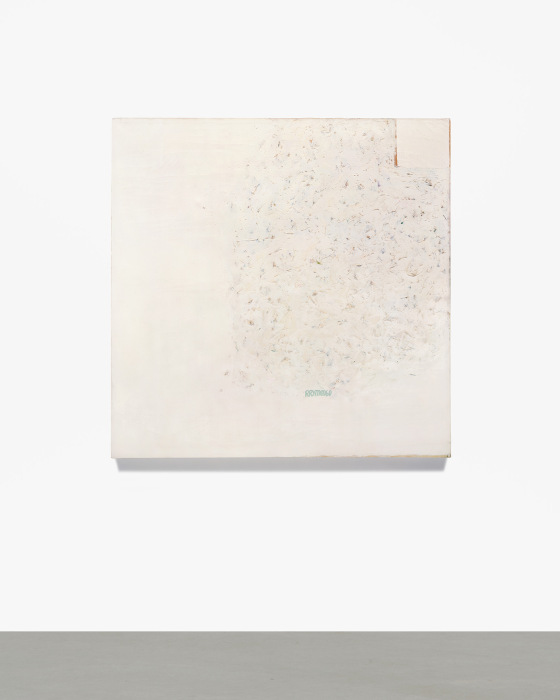 pale canvas hangs on a white gallery wall
