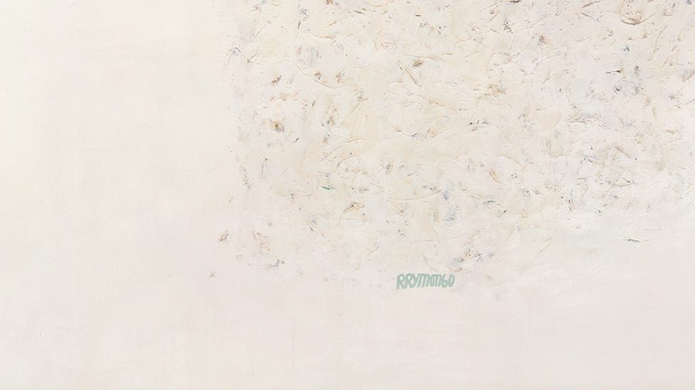 pale canvas hangs on a white gallery wall