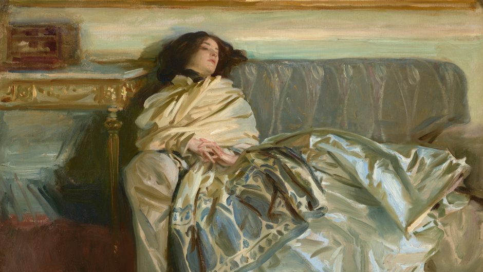 A woman lies on a sofa