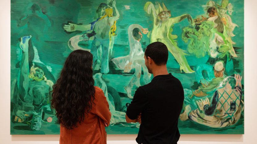 Two people stand in front of Salman Toor's large scale painting, Ghost Ball